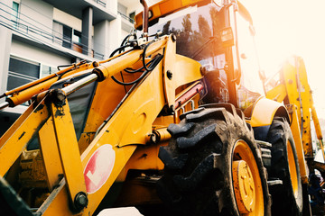 Yellow construction vehicle parking prepare for working - obrazy, fototapety, plakaty