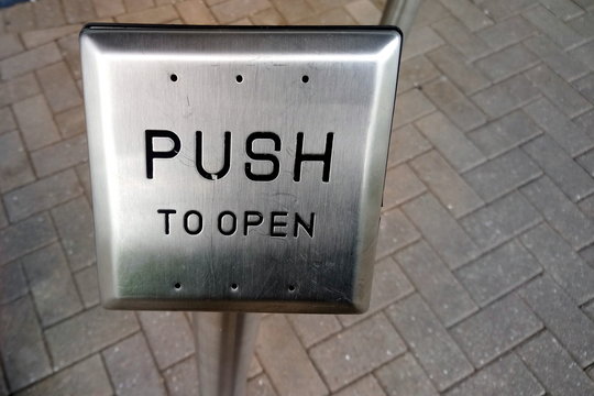 Push button to allow wheelchair users to open an automatic door. Copy space for text