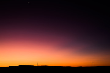 Vibrant Rural Montana Sunrise with Power Lines Silhouette