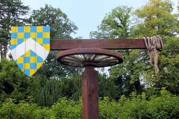 Medieval quintain with shield on a revolving post used for jousting practice
