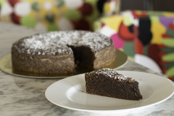 Delicious piece of chocolate brownie on a plate on the table