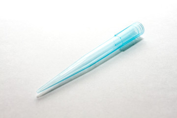 A blue disposable micro pipette tips for lab or laboratory on white background