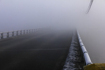 A bridge in dense fog