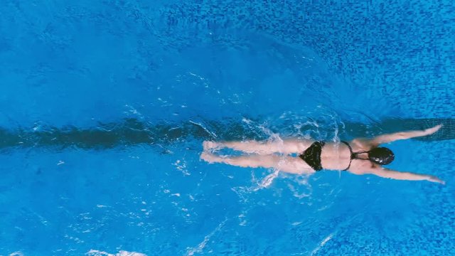A swimmer uses her legs in a fishtail kick during butterfly strokes. 