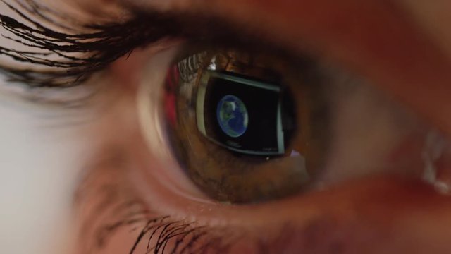 MACRO CLOSEUP Blinking eye looking at world map. Computer screen image, seen in a reflection on the eyeball surface, zooming into location. Unidentified female planning terrorist attack in Washington.