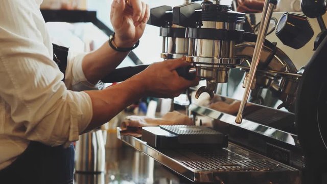 barista making coffee with espresso machine 