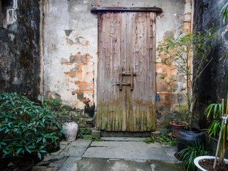 Traditional Chinese rural wooden door, closed.