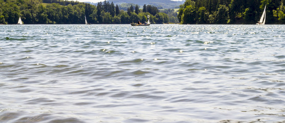 Blue sky and water with sailboats