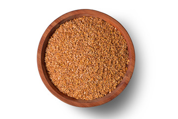 Golden linseeds on wooden bowl isolated on white background