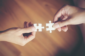 Hand holding jigsaw puzzles, Business partnership concept.