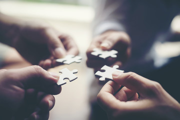 Hand holding jigsaw puzzles, Business partnership concept. - obrazy, fototapety, plakaty