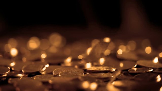 Close up money coin falling to the floor in dark light , business and financial for a  money saving or investment background concept with black copy space , extremely close up and shallow DOF