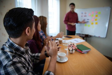 Happy group of business people clapping in office meeting hands applauding at conference success and perfect presentation.