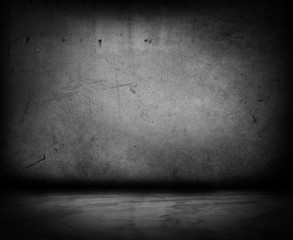 Empty grey concrete wall and floor in dark room background. Copy space
