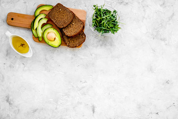 Fototapeta na wymiar Avocado toast for light healthy breakfast on grey background top view copy space