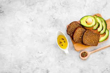 Vegetarian breakfast. Sandwiches with avocado and rye bread on grey background top view copy space