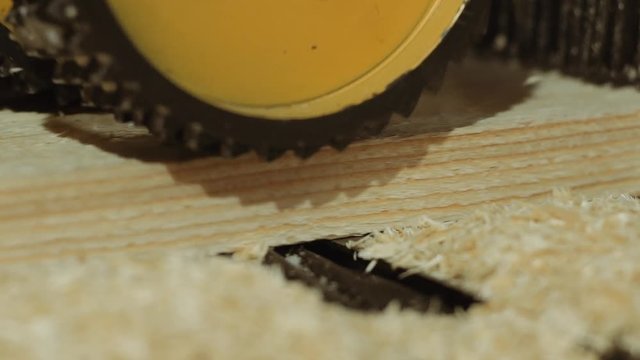 Rolling spiked wheels of plank refiner machine working on wood at lumber production, close up