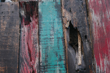 Colorful vintage wooden panel on black background with copy space.Broken vintage wood texture and background.