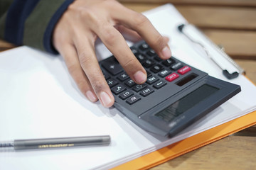Close up shot of man hand using calculator.Man using calculator.