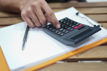 Close up shot of man hand using calculator.Man using calculator.