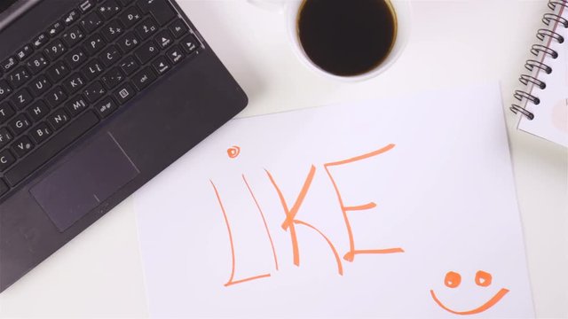 LIKE word with smile emoticon on empty paper office desk 4K