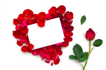 Blank gift card on heart shape ofred rose petals on white background. 