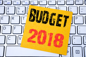 Budget 2018. Business concept for Household budgeting accounting planning written on sticky note paper on the white keyboard background.