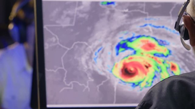 Weather professional monitoring hurricane activity