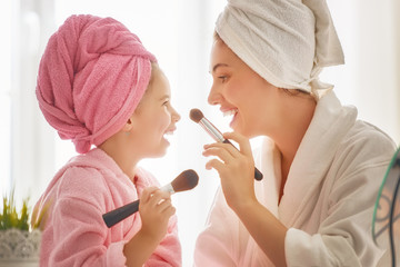 Mother and daughter are doing make up