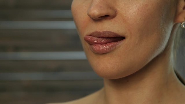 Hot blonde girl licks his lips. tongue work. slow motion