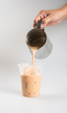 Iced tea or coffee with milk on a background.