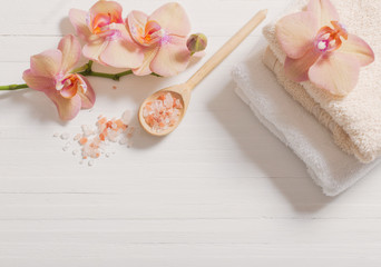 orchid with towels on white wooden background
