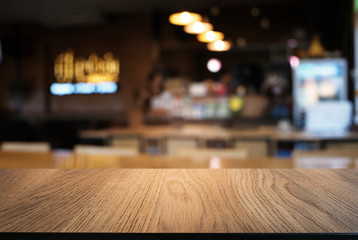 Empty wooden table in front of abstract blurred background of coffee shop . can be used for display or montage your products.Mock up for display of product.