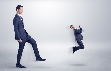 Small man fired by boss with white wallpaper