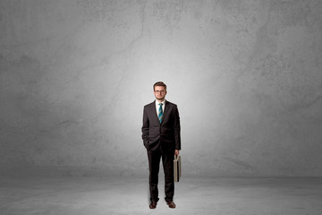 Alone businessman standing in a dark room