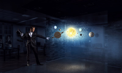 Businessman demonstrating magic . Mixed media