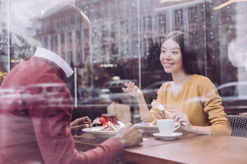 Good date. Satisfied pleased pleasant couple dating while woman gesturing and telling story