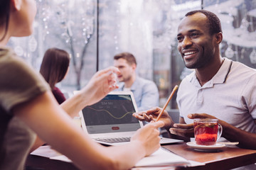 Perspective project. Joyful glad gay man gesturing while smiling and explaining his thought