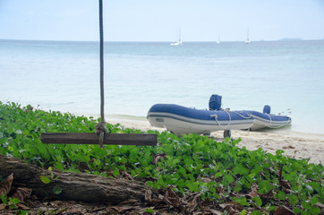 inflatable motor boat on the beach in sunny day