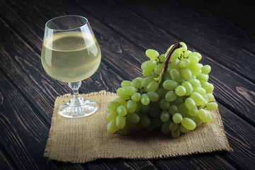 fresh green grapes and wineglass