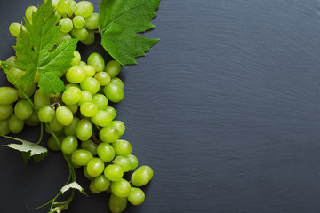 green grape on black stone background