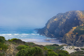 Beach in the morning mist at sunrise