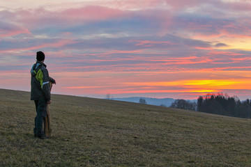 Young man stand and looking into winter sunrise, Czech landscape