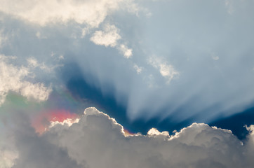 Nice dramatic sky, Iridescence over clouds with sun ray shine in blue sky background