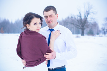 Happy Couple in Winter Park with romantic mood .Family Outdoors. love at 14 february, outdoor fashion portrait of sensual couple in cold winter weather. lovers and kisses 