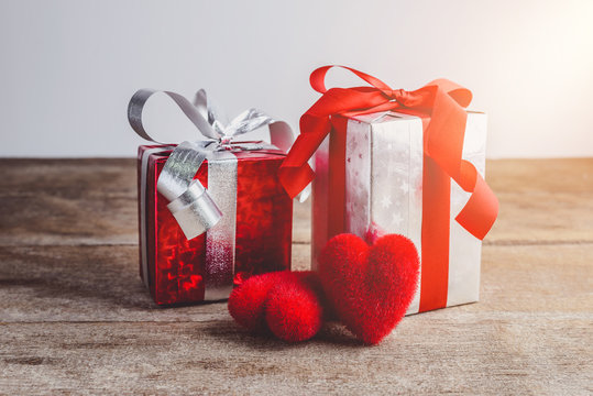 Red heart and gift box on a wooden background