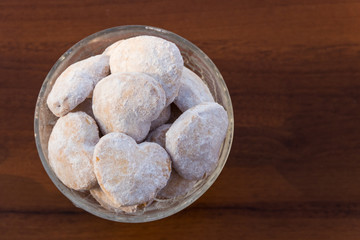 Plate with heart shaped cookies covered with powdered sugar