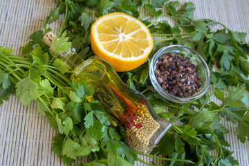 Lemon, olive oil, fresh parsley and smoked salt - products for salad dressing.