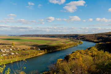 Obraz premium Autumn Landscape - river, sky with clouds, fields.