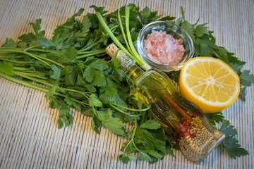 Lemon, olive oil, fresh parsley and Himalayan salt - products for dressing salads.